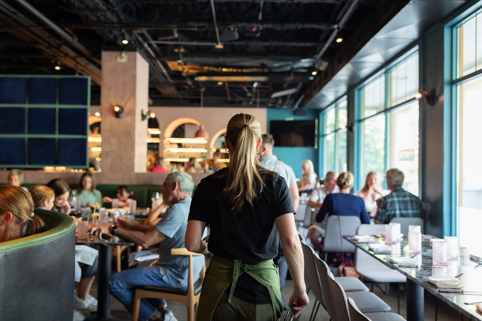 Cafe staff walking toward customer