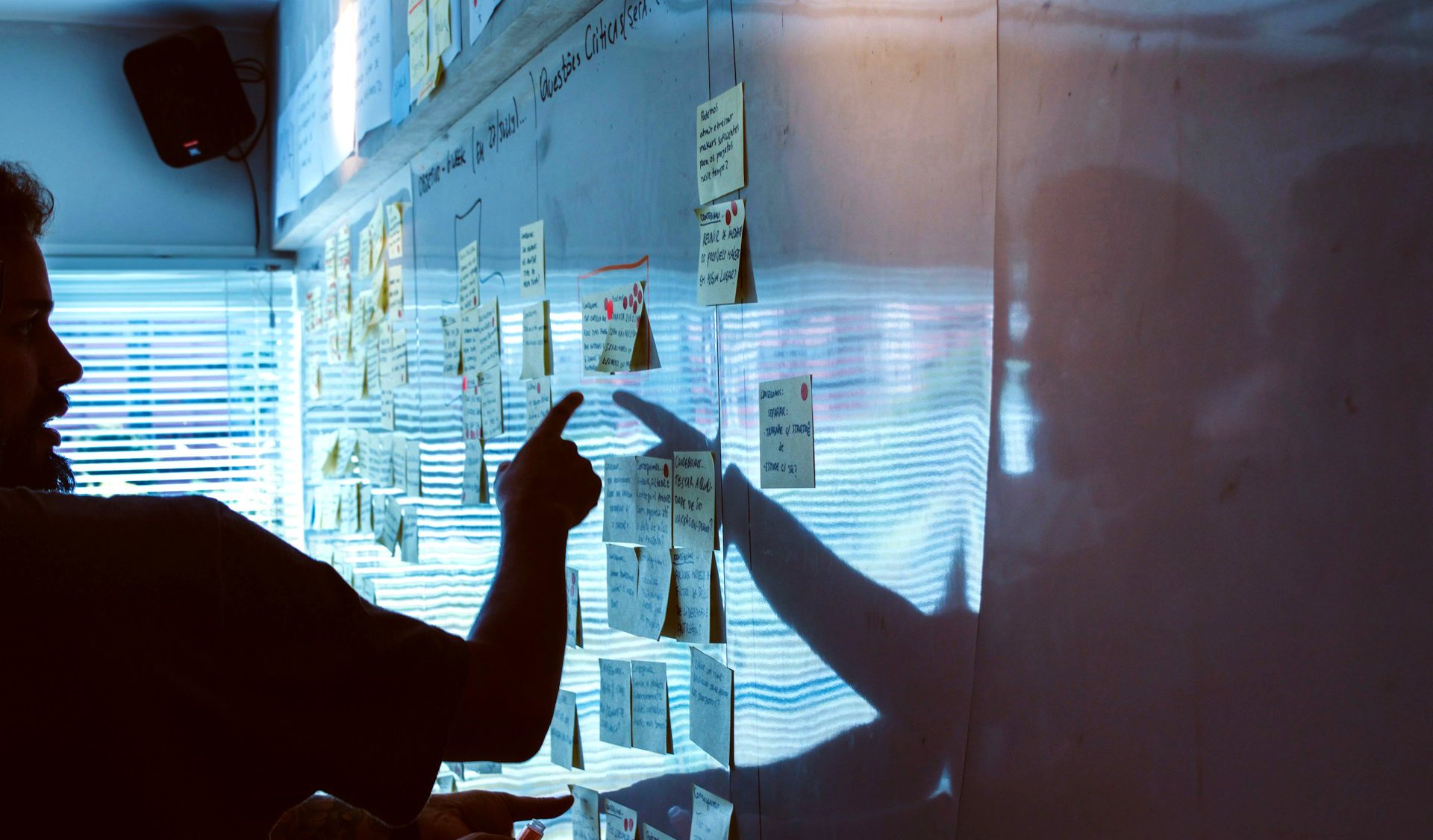 Person pointing at a whiteboard