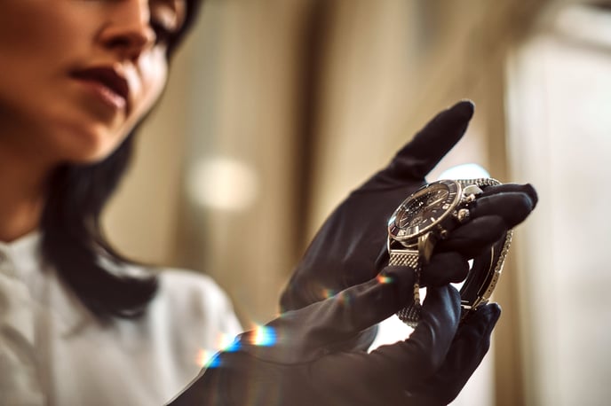 woman-holding-up-a-luxury-watch