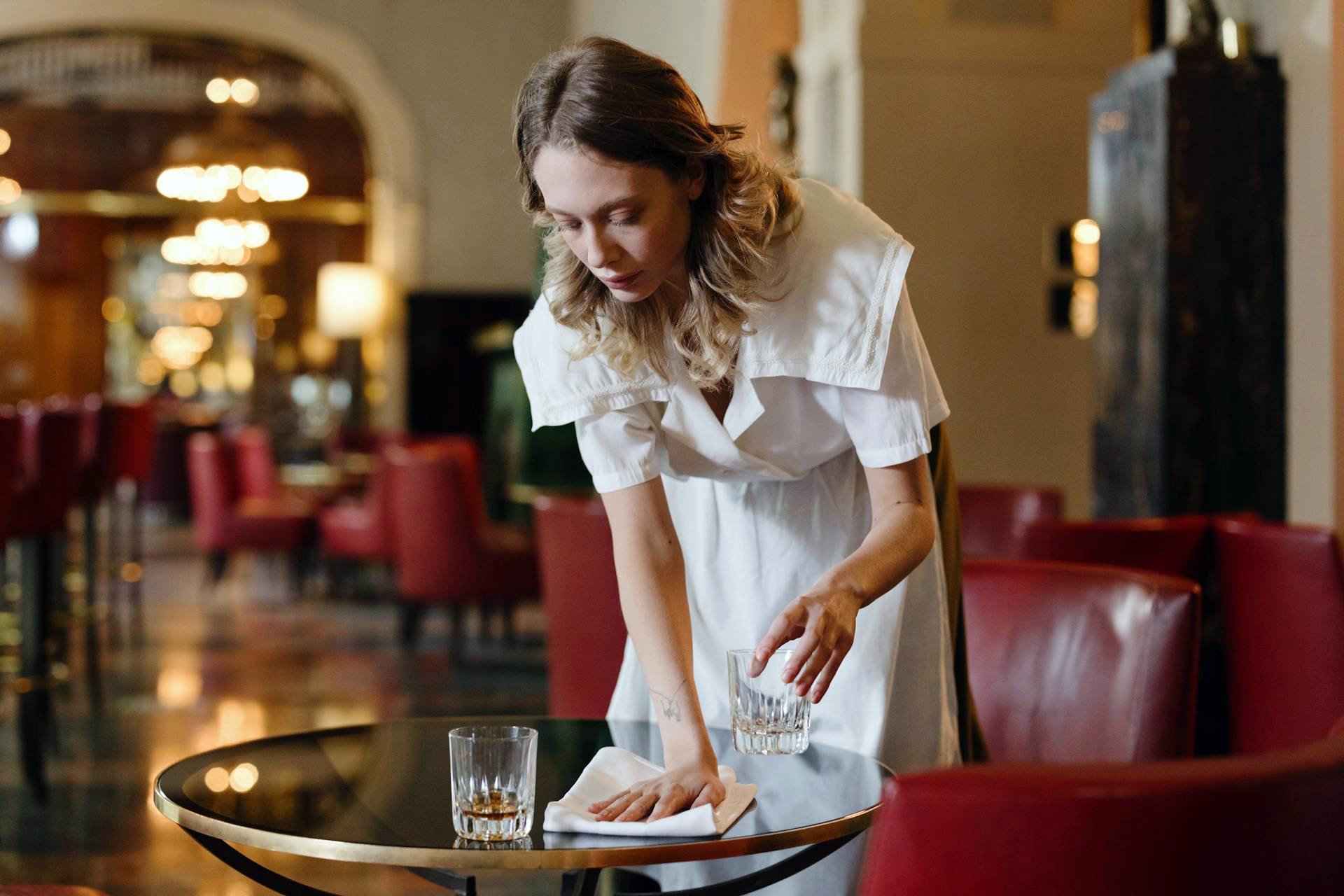 Woman wiping down a table