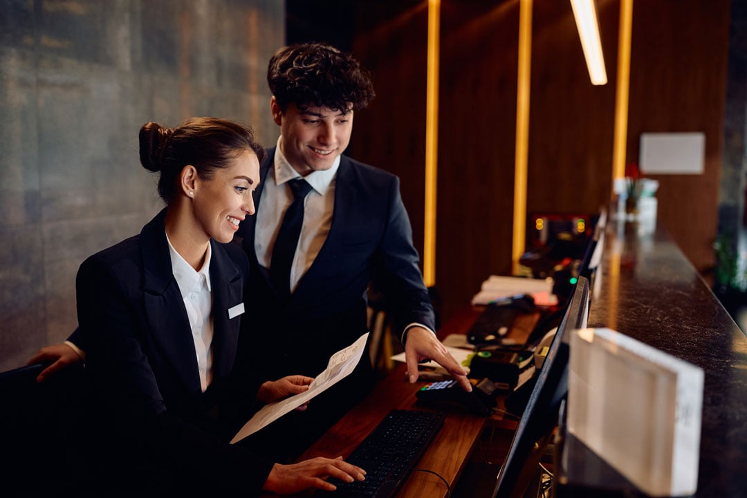 receptionists working at a hotel reception