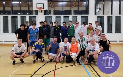A group picture after the staff versus students soccer game