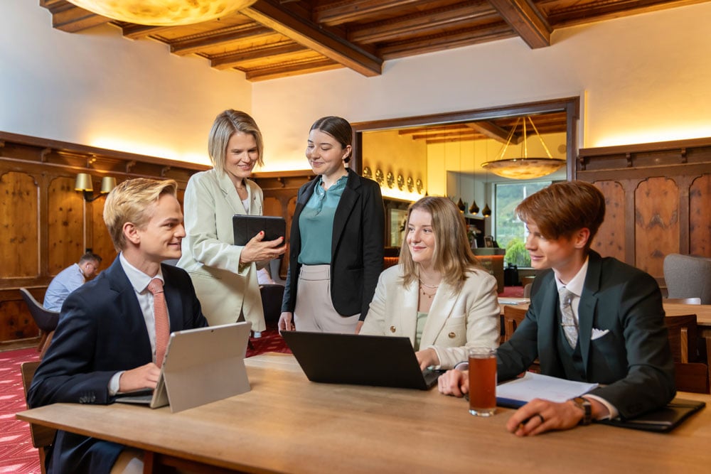 EHL Passugg teacher coaching hospitality students in the lobby